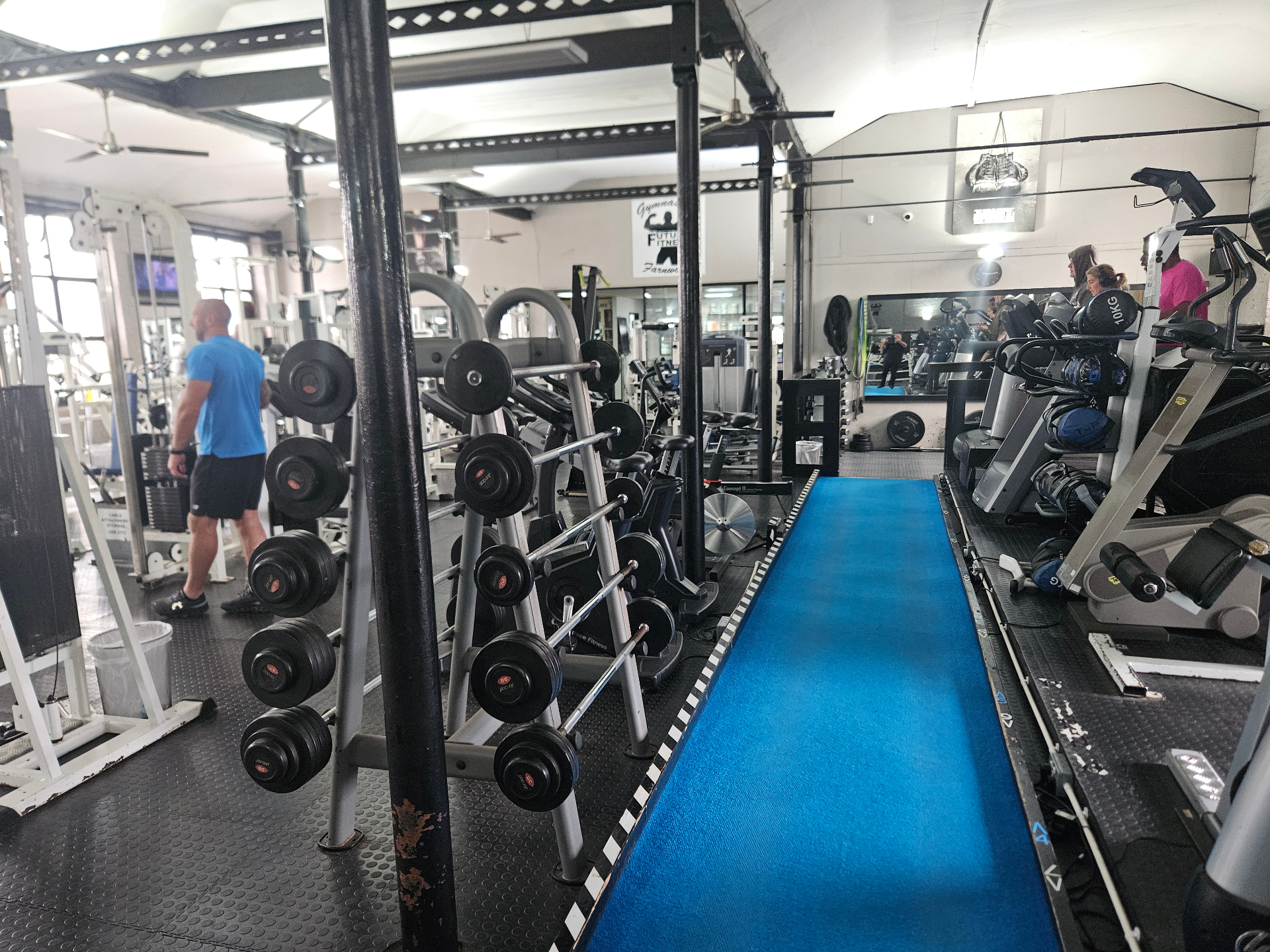 Fixed barbell rack alongside the blue running track
